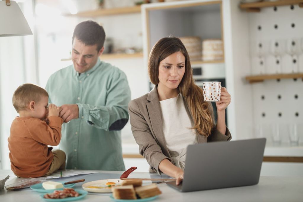 mom looking at computer to plan family reunion