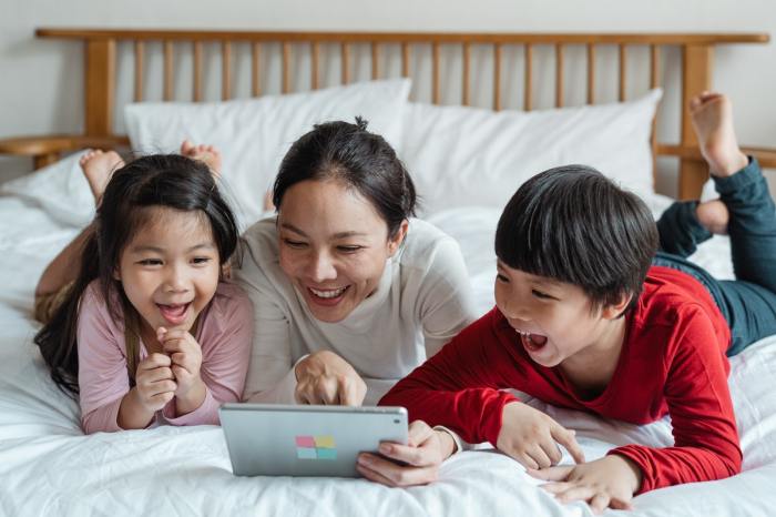 A happy family looking at a laptop planning a trip.