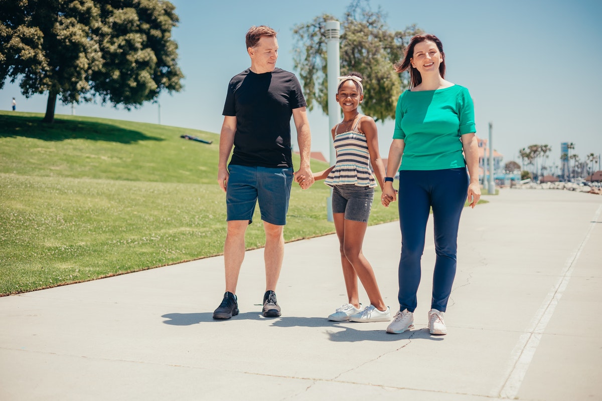 A family taking a walk on a sunny day.