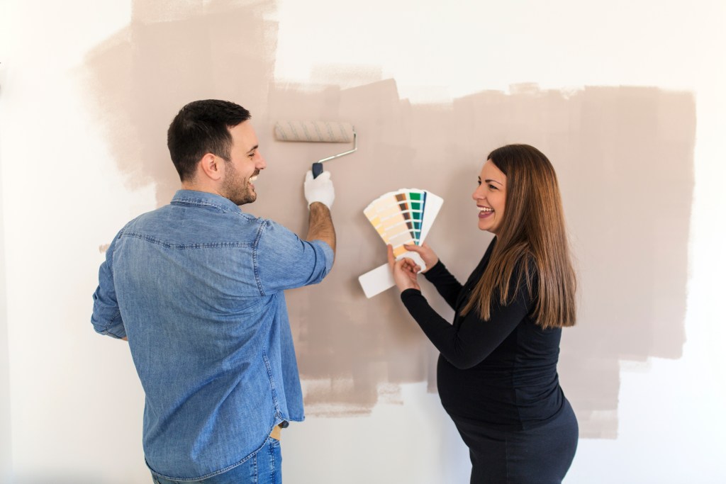 couple painting a nursery