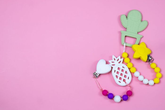 baby teethers on a pink background