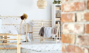 Rustic nursery with brick wall.