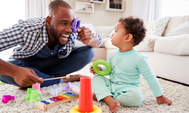 A dad playing with his toddler.