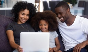 A family gathered around the computer