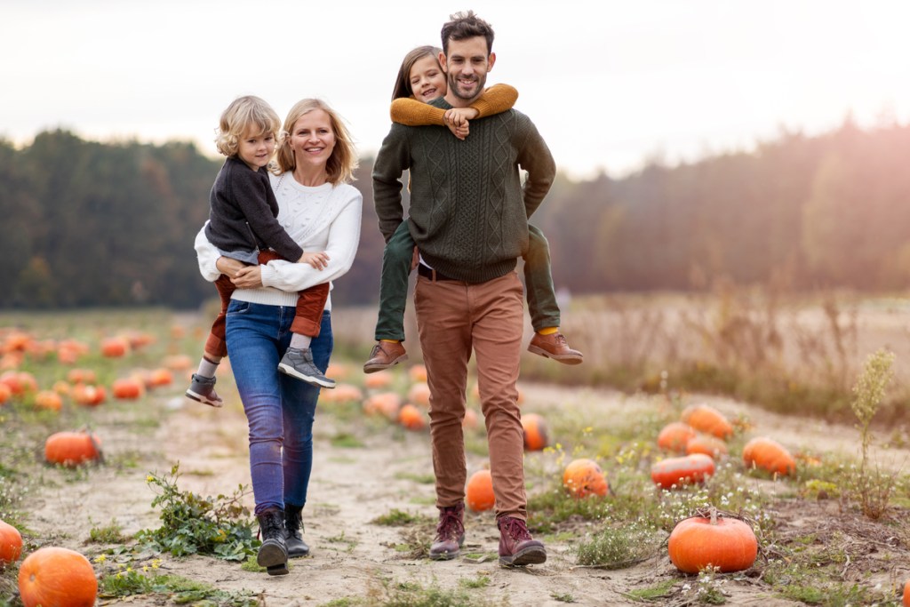 A family having fun in a pumpkin patch