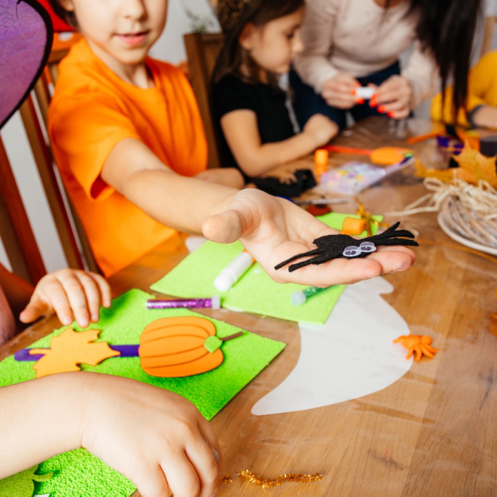 A group of children doing a Halloween craft.