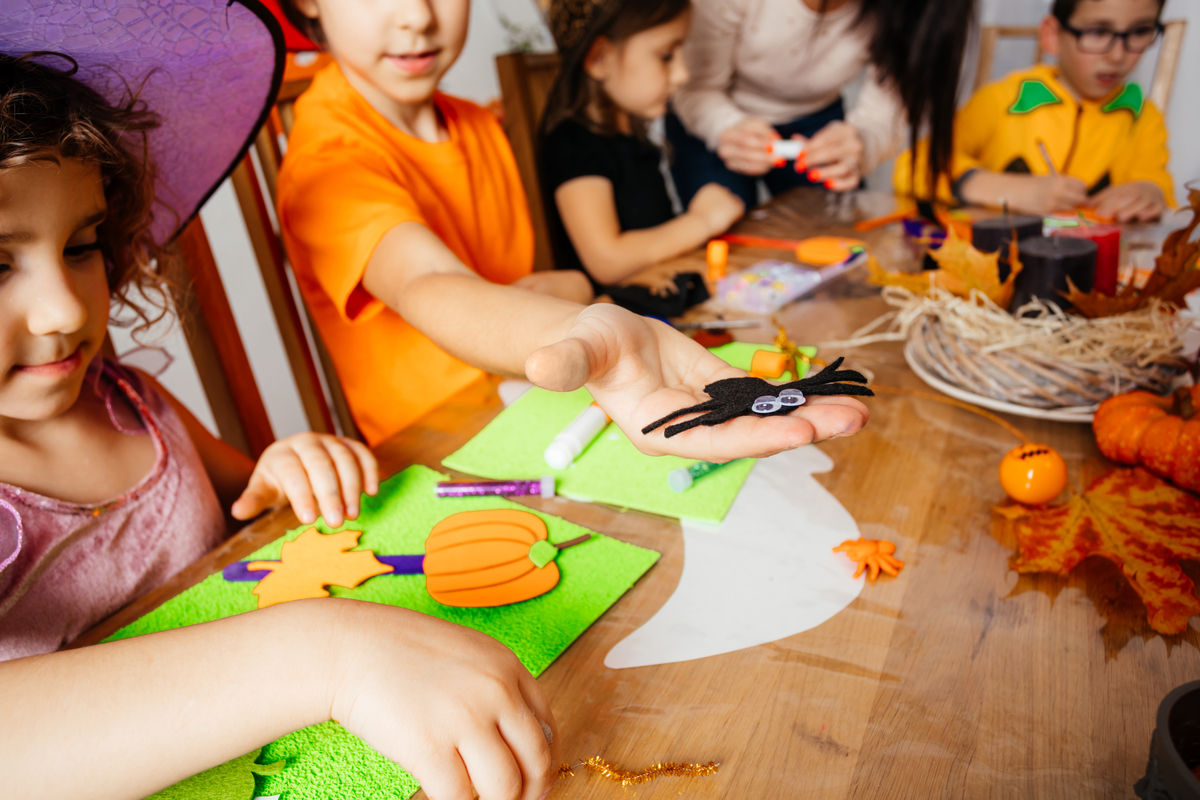 A group of children doing a Halloween craft