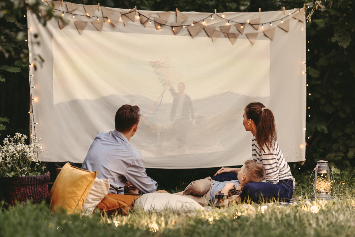 A family enjoying an outdoor movie night.
