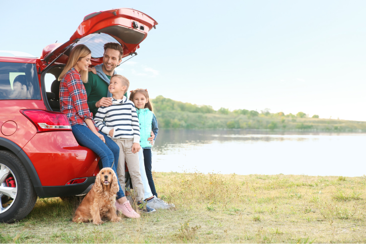 A family taking a break from a road trip.