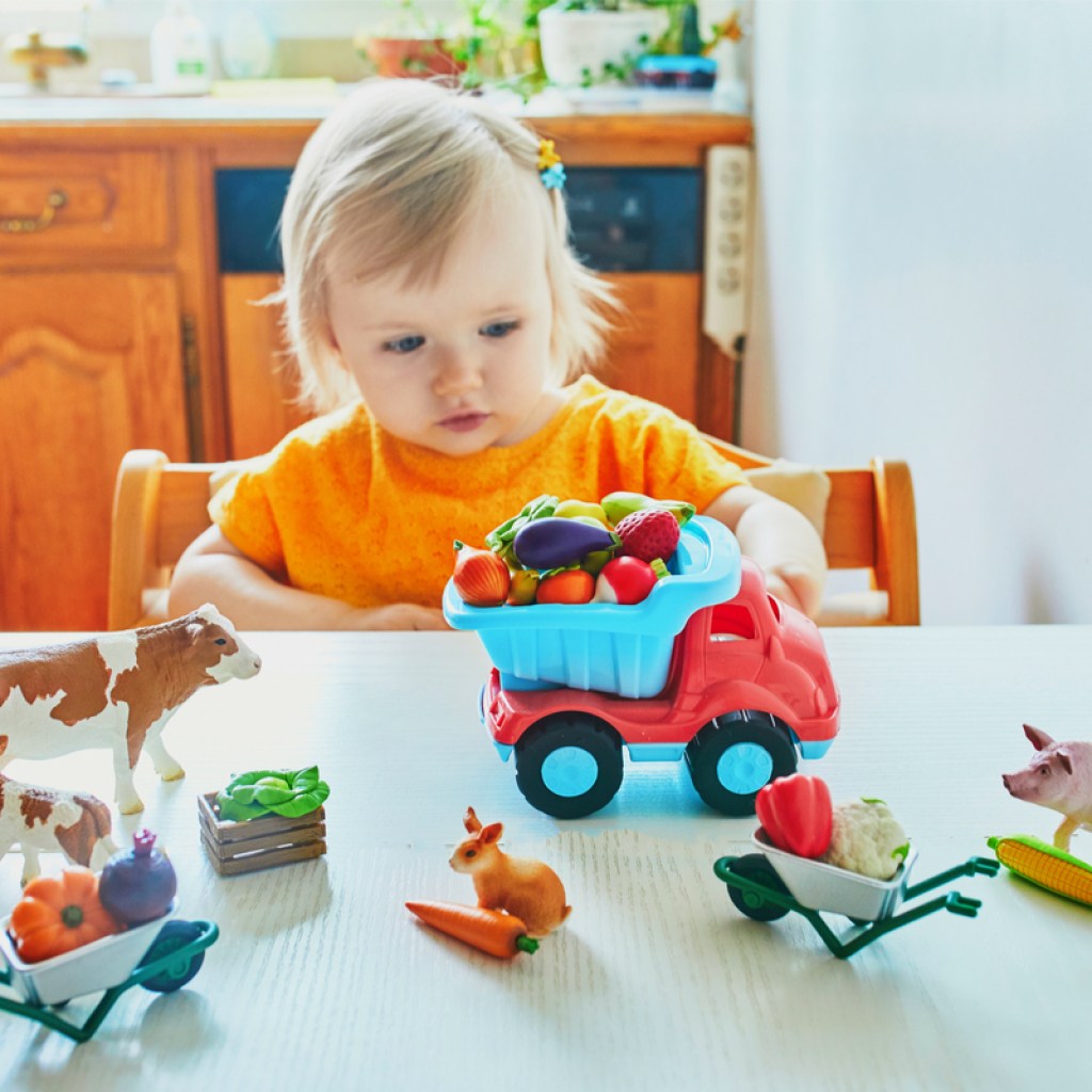 toddler girls having playing with farm toys
