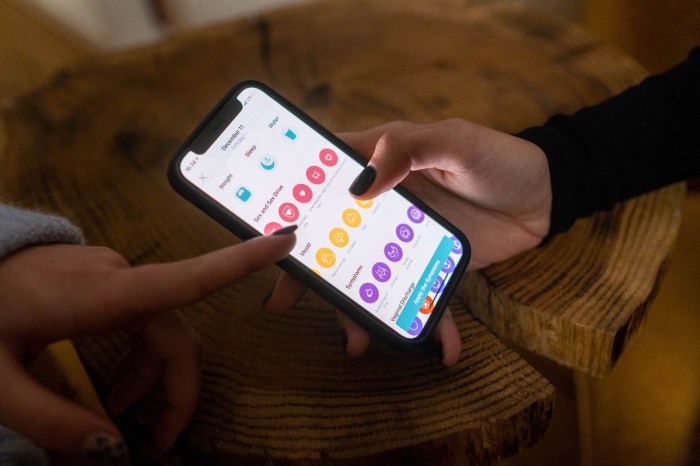 woman putting data into a menstrual cycle app