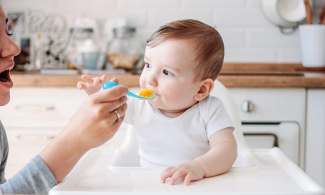 Baby eating pumpkin