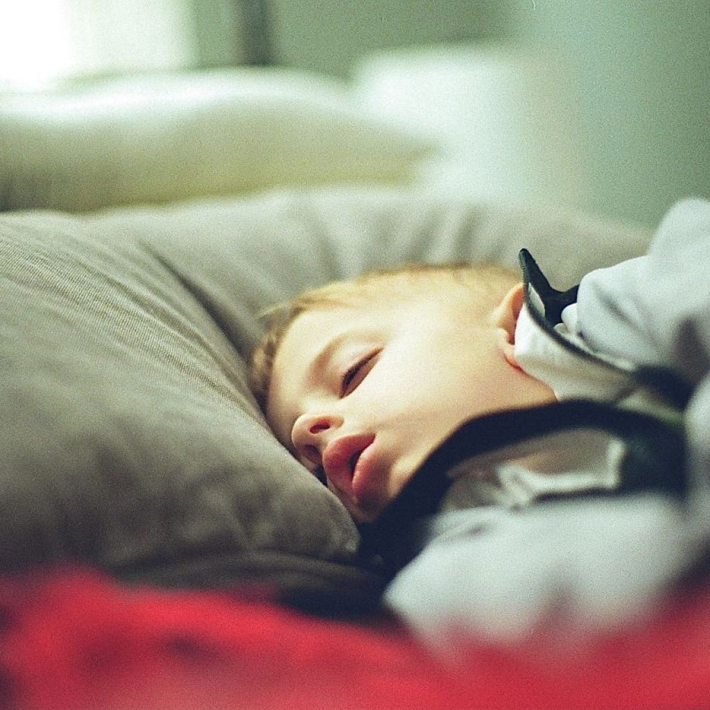 Little boy sleeping in bed