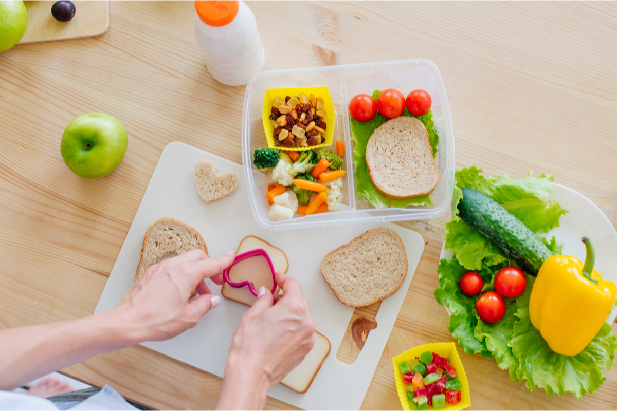 parent putting together a colorful lunch