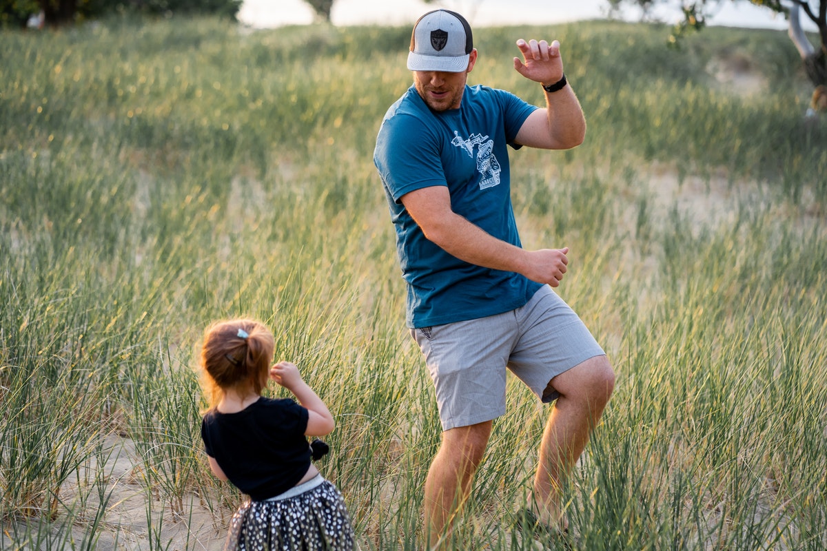Dad and daughter dancing outside