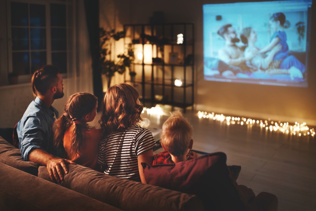 Family watching a movie together for a family fun night