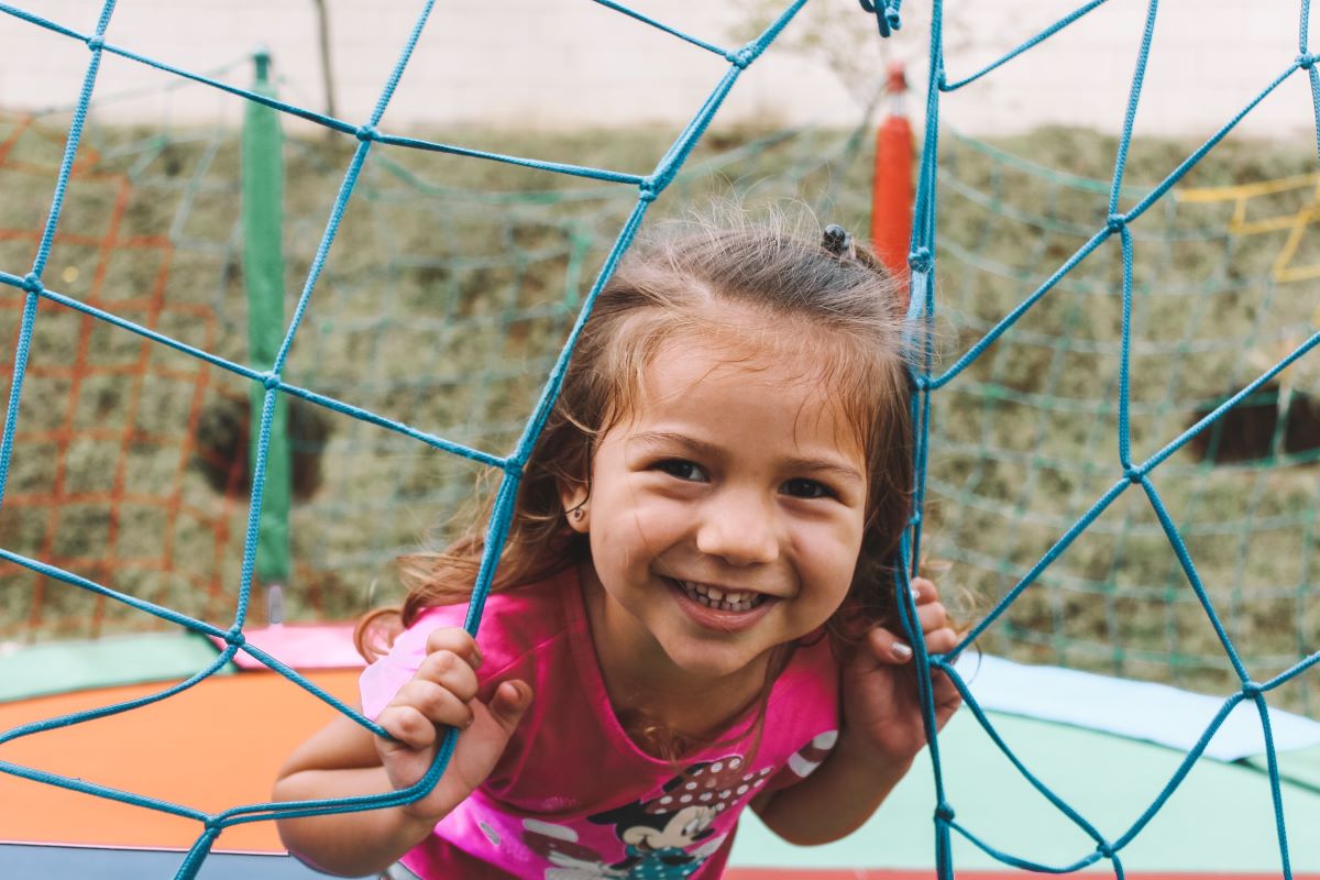 little girl jumping on trampoline