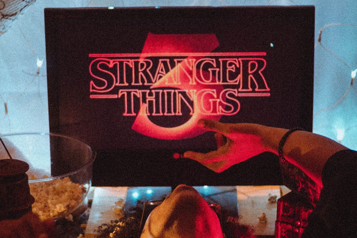 Person watching Stranger Things on television