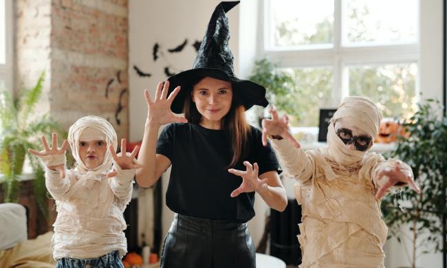 A mom and her kids dressed up for Halloween.