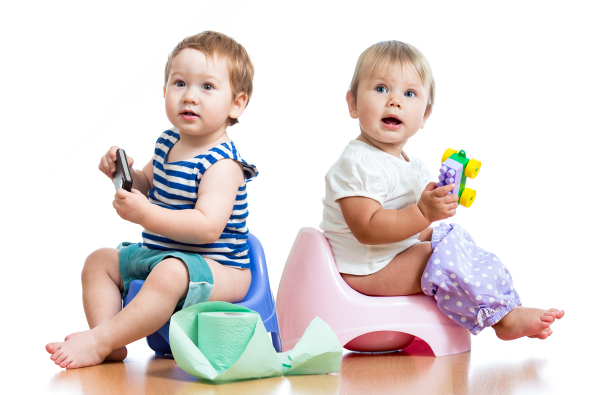 A couple of toddlers on the potty.