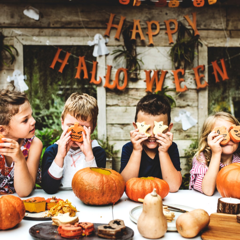 A group of kids doing a Halloween activity.