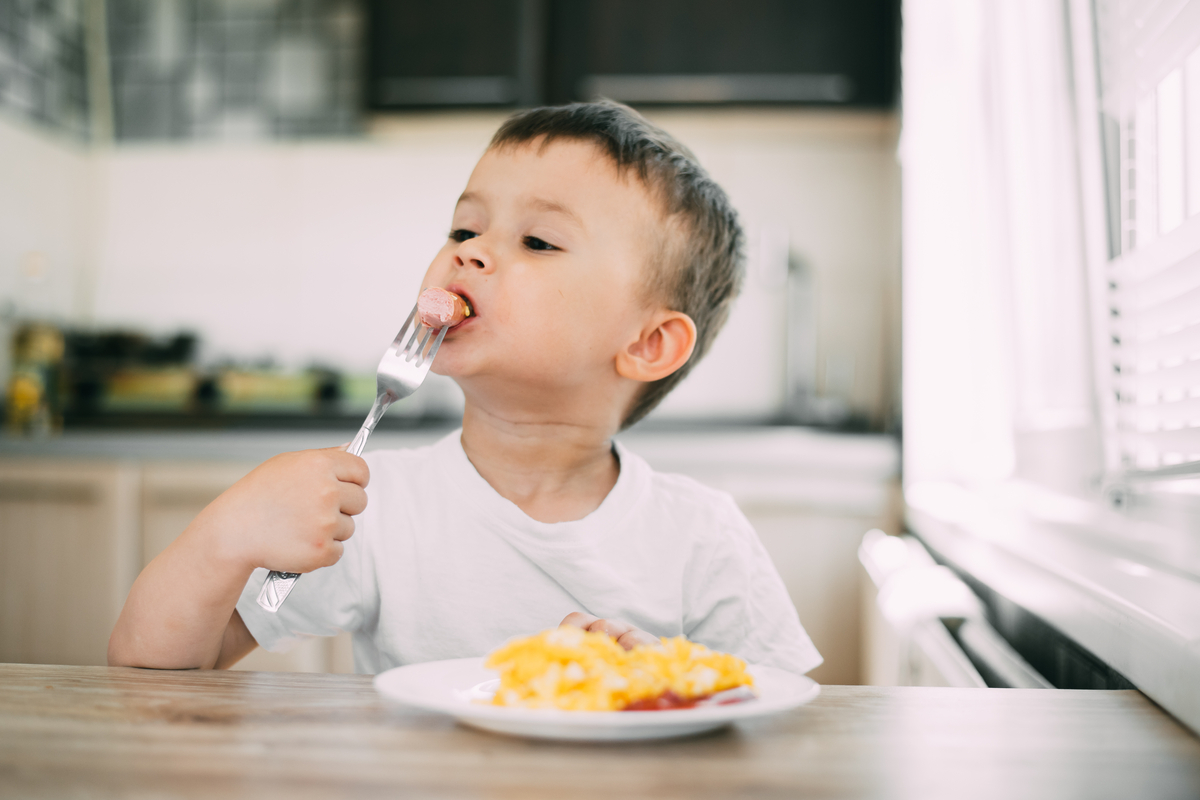 A toddler eating his dinner.