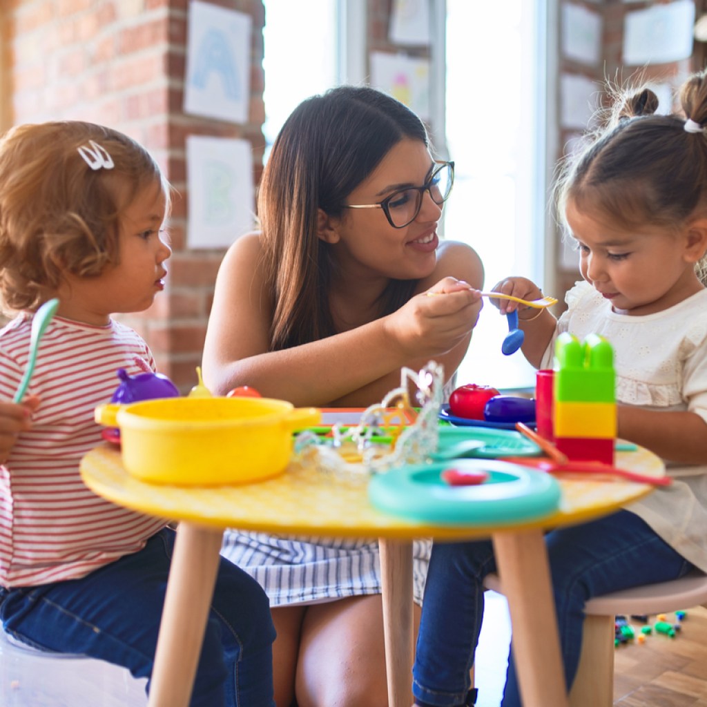 A mom feeding her toddlers.