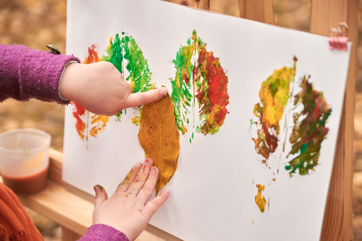 A child making a leaf painting