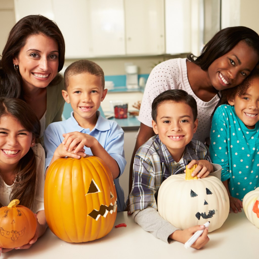 A couple of families enjoying Halloween crafts together.