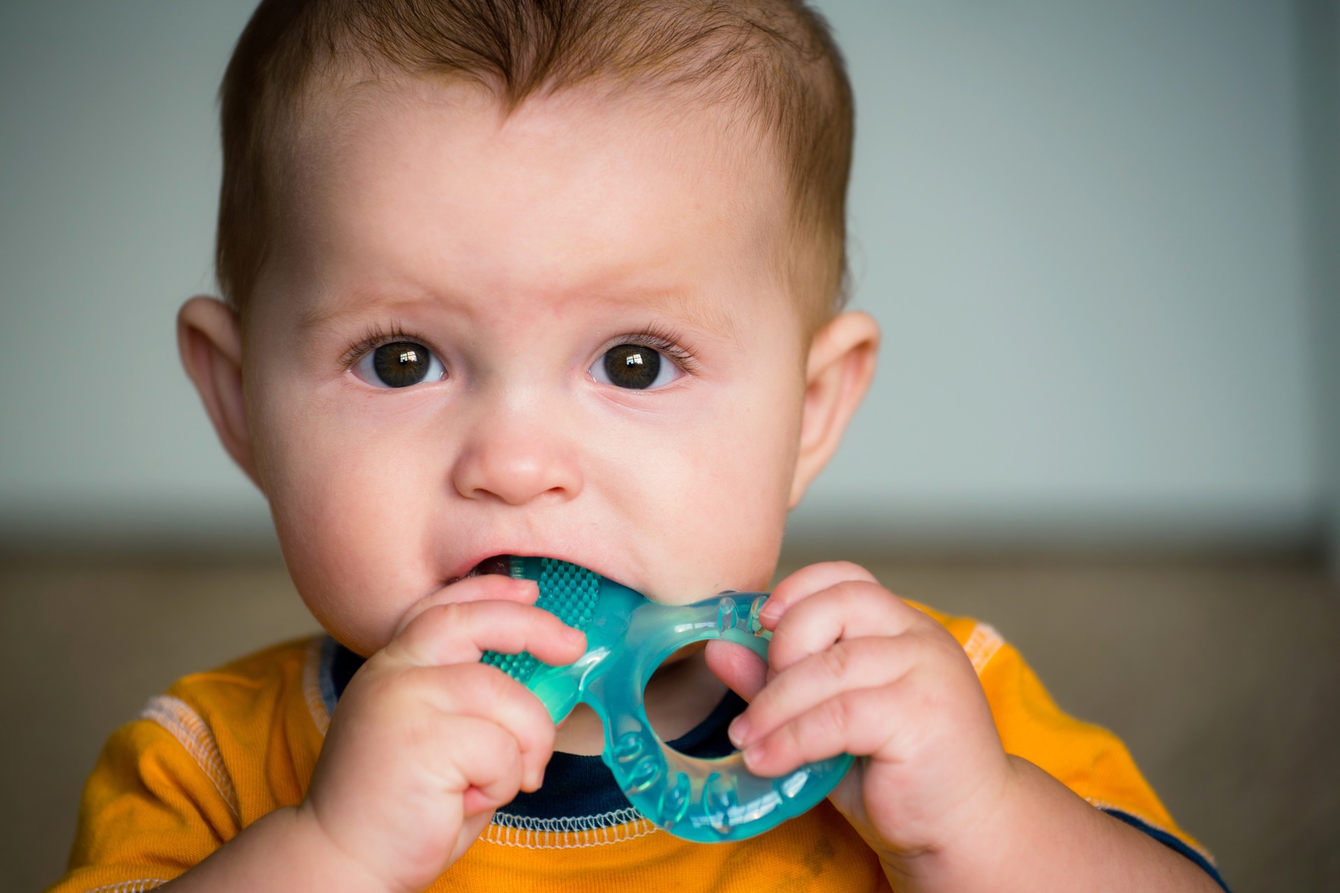 child holding a teething ring