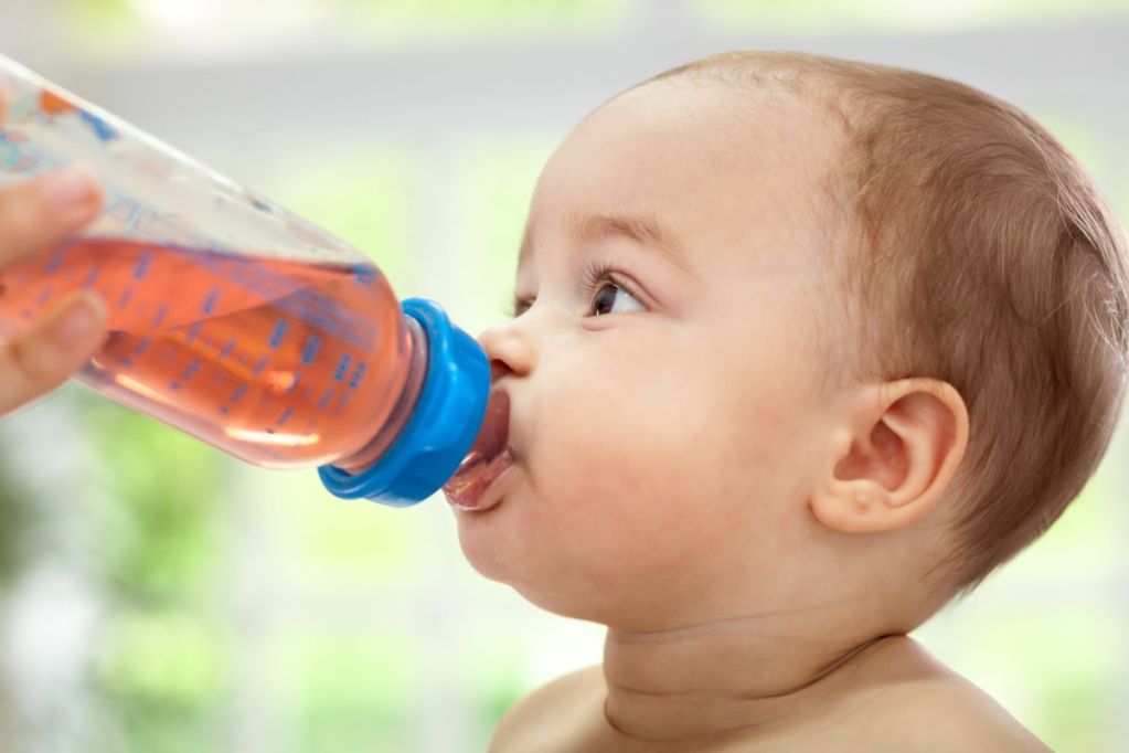 Baby drinking out of a bottle.