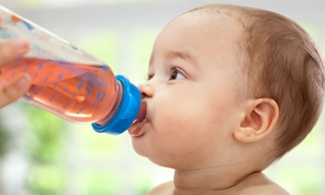 Baby drinking out of a bottle.