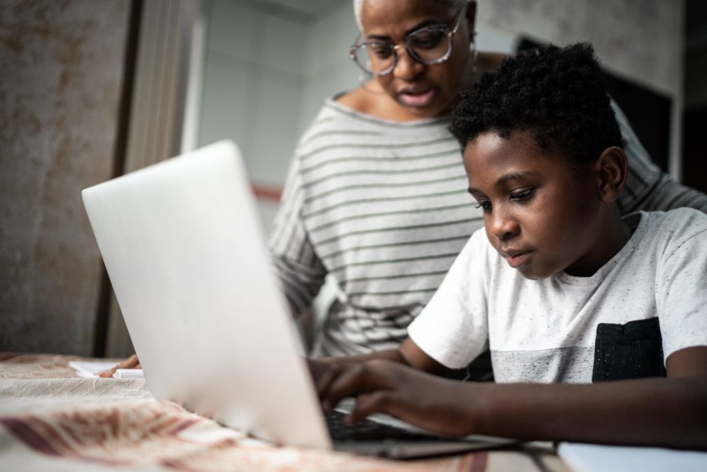 Parent helping a child on the laptop