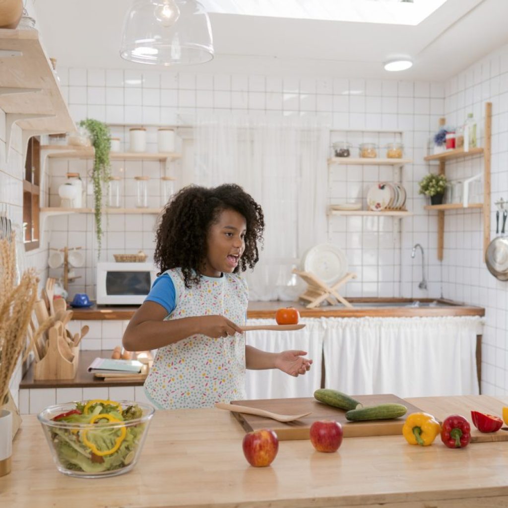 A kid making themselves some food in the kitchen.
