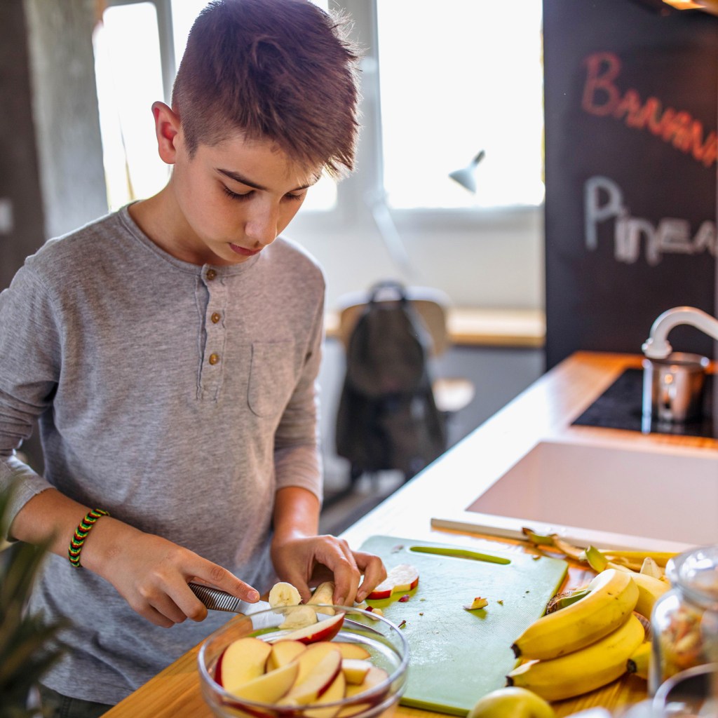 A child making themselves a snack.