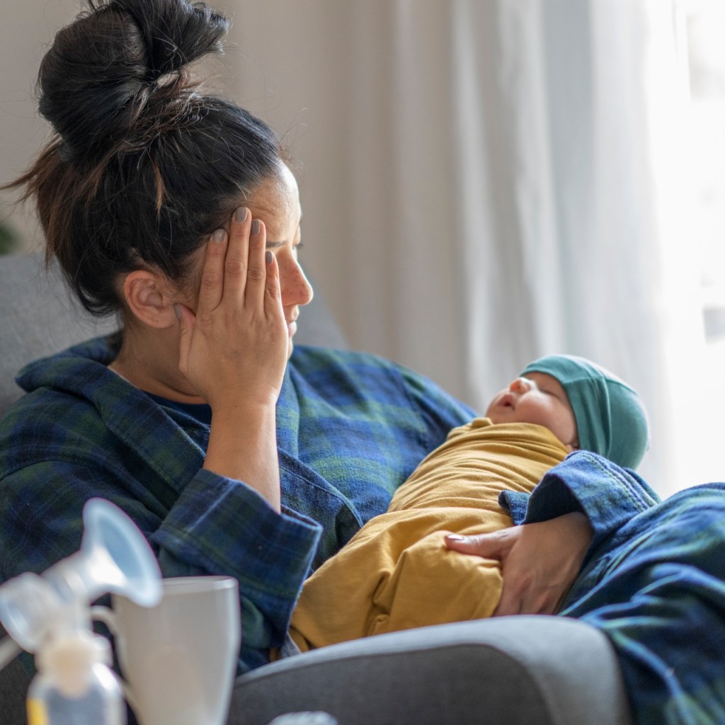 Mom feeling under the weather holding baby