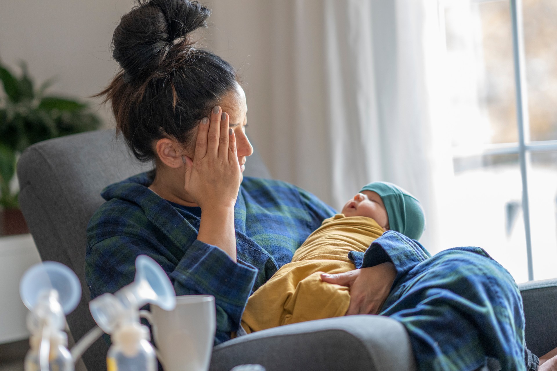 Mom feeling under the weather holding baby