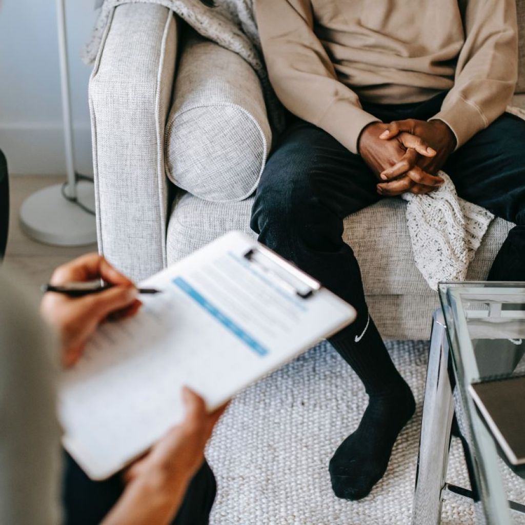 Male patient sitting across from therapist