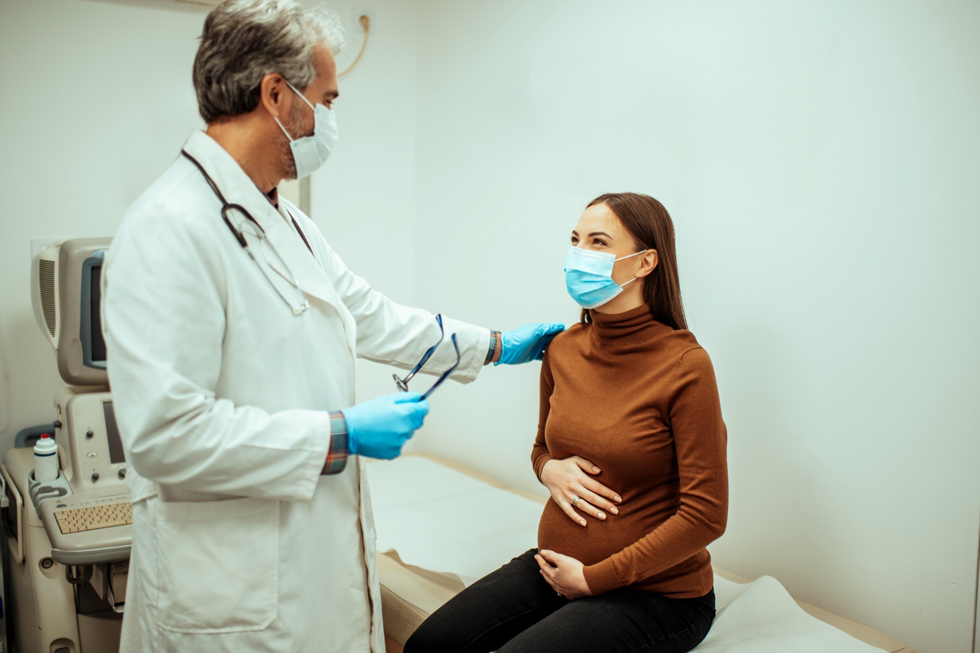 Pregnant mom and doctor in office