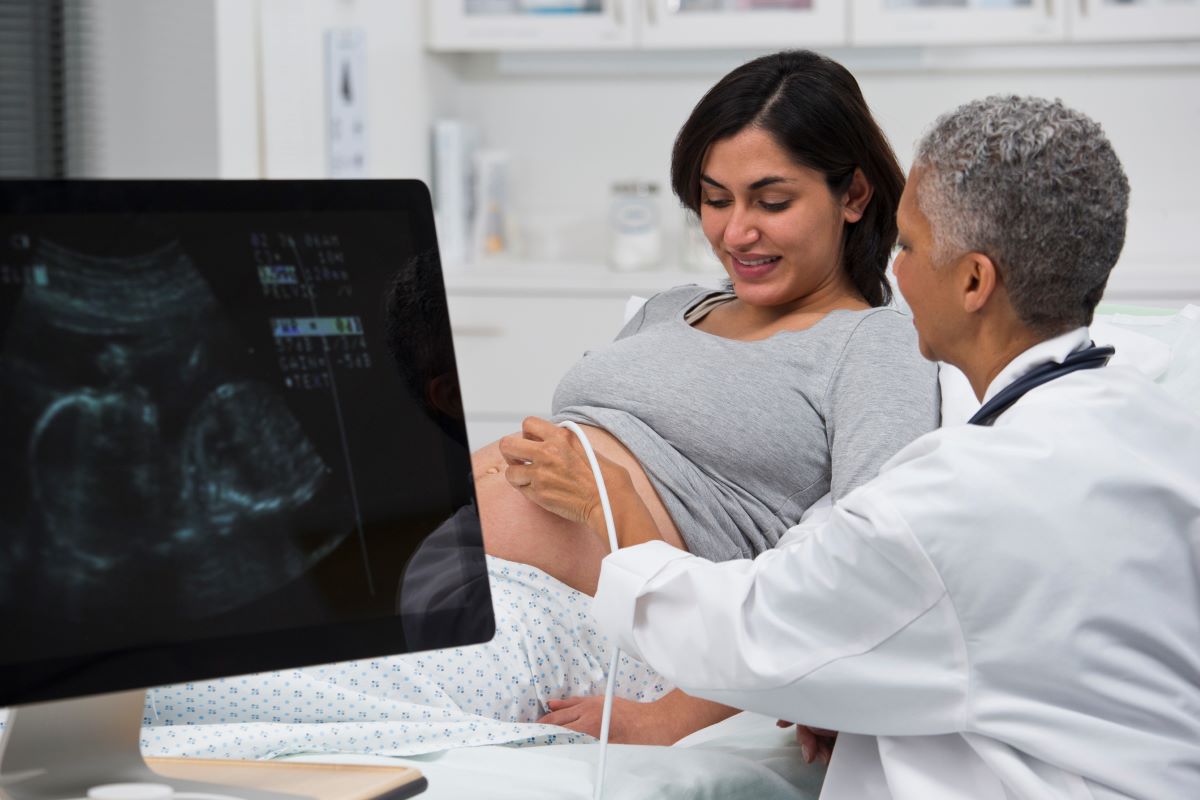 Sonographer performing an ultrasound on an expecting mom