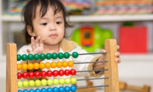 Toddler learning to count with an abacus