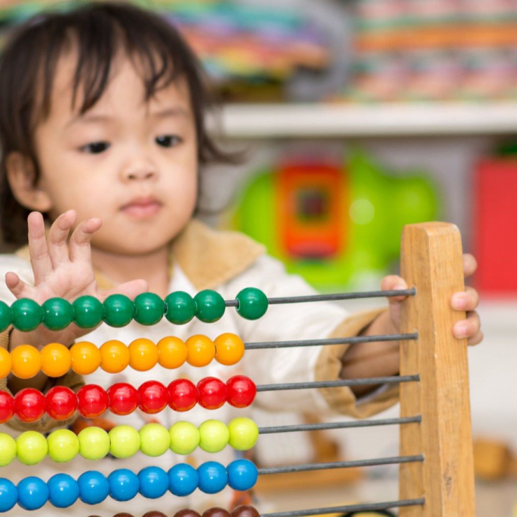 toddler learning to count with an abacus