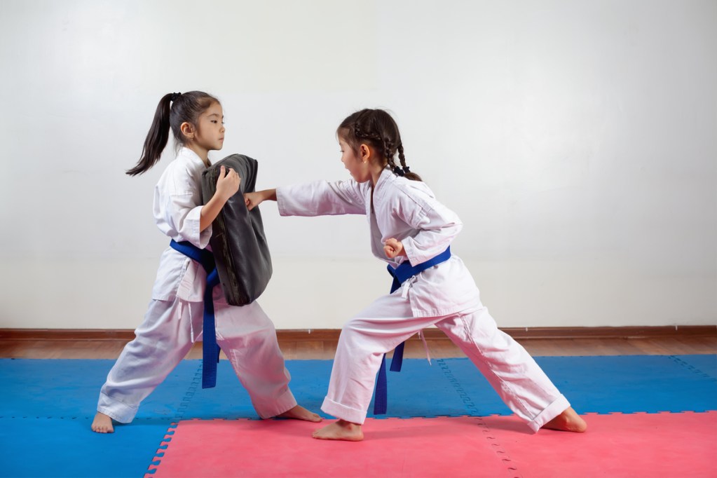 Two girls practicing karate