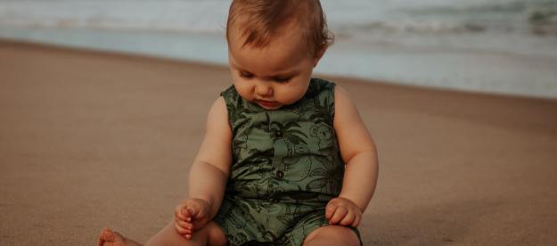 Baby sitting on the beach