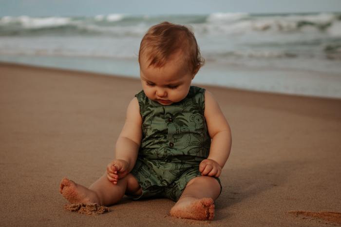 Baby sitting on the beach