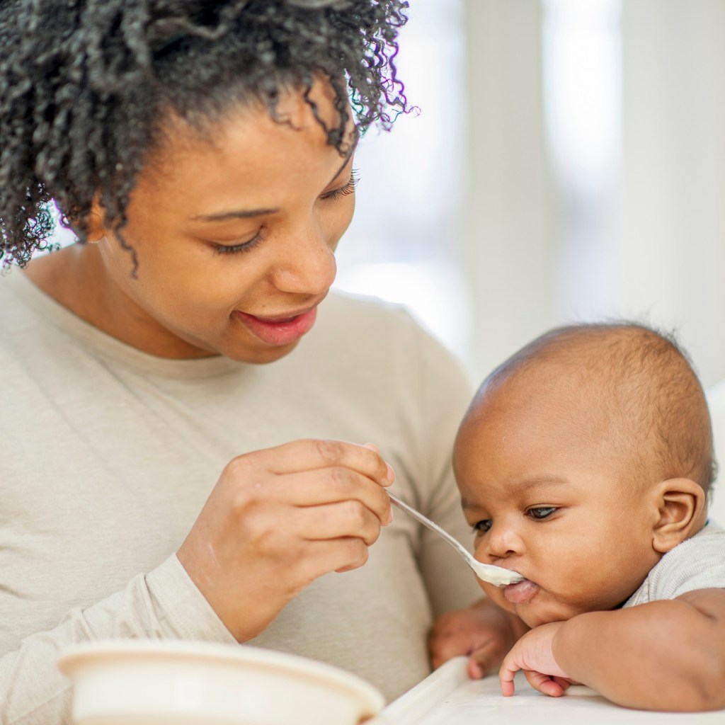A parent feeding a baby.