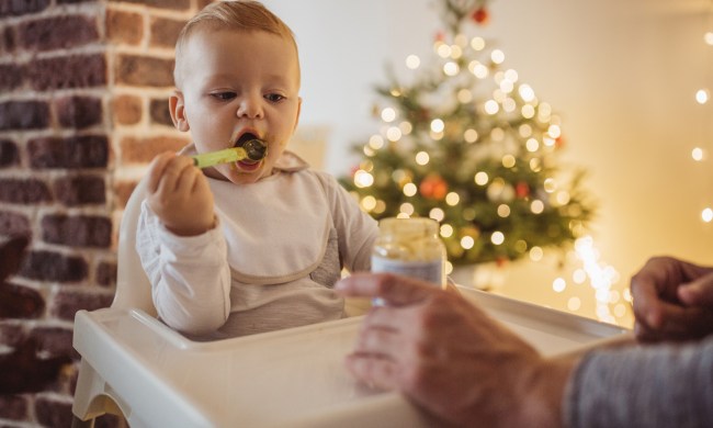 Baby eating puree in a highchair at Christmas
