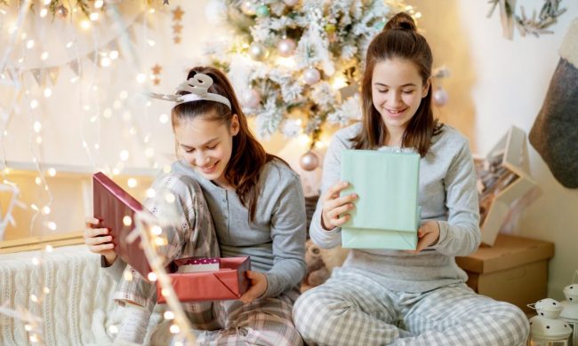 Teenage girls looking at presents they are opening