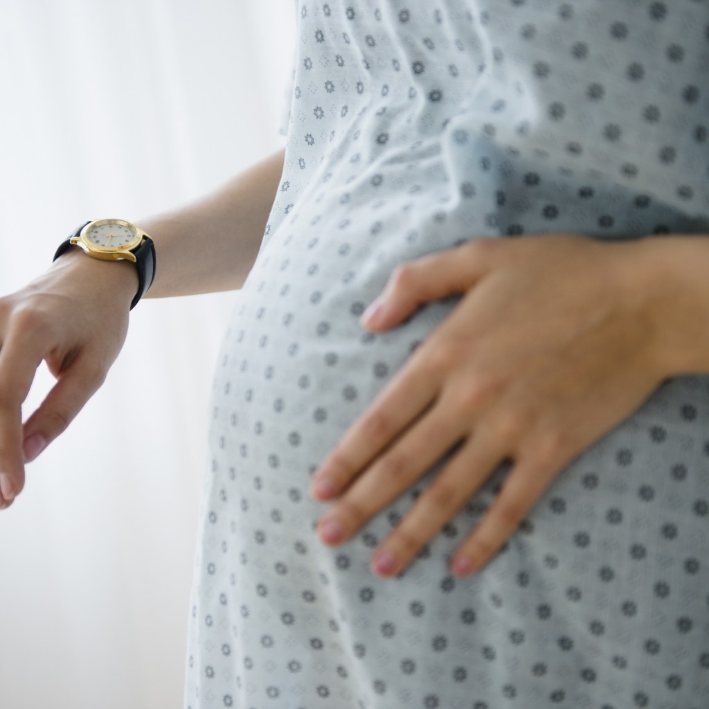 Pregnant woman timing contractions