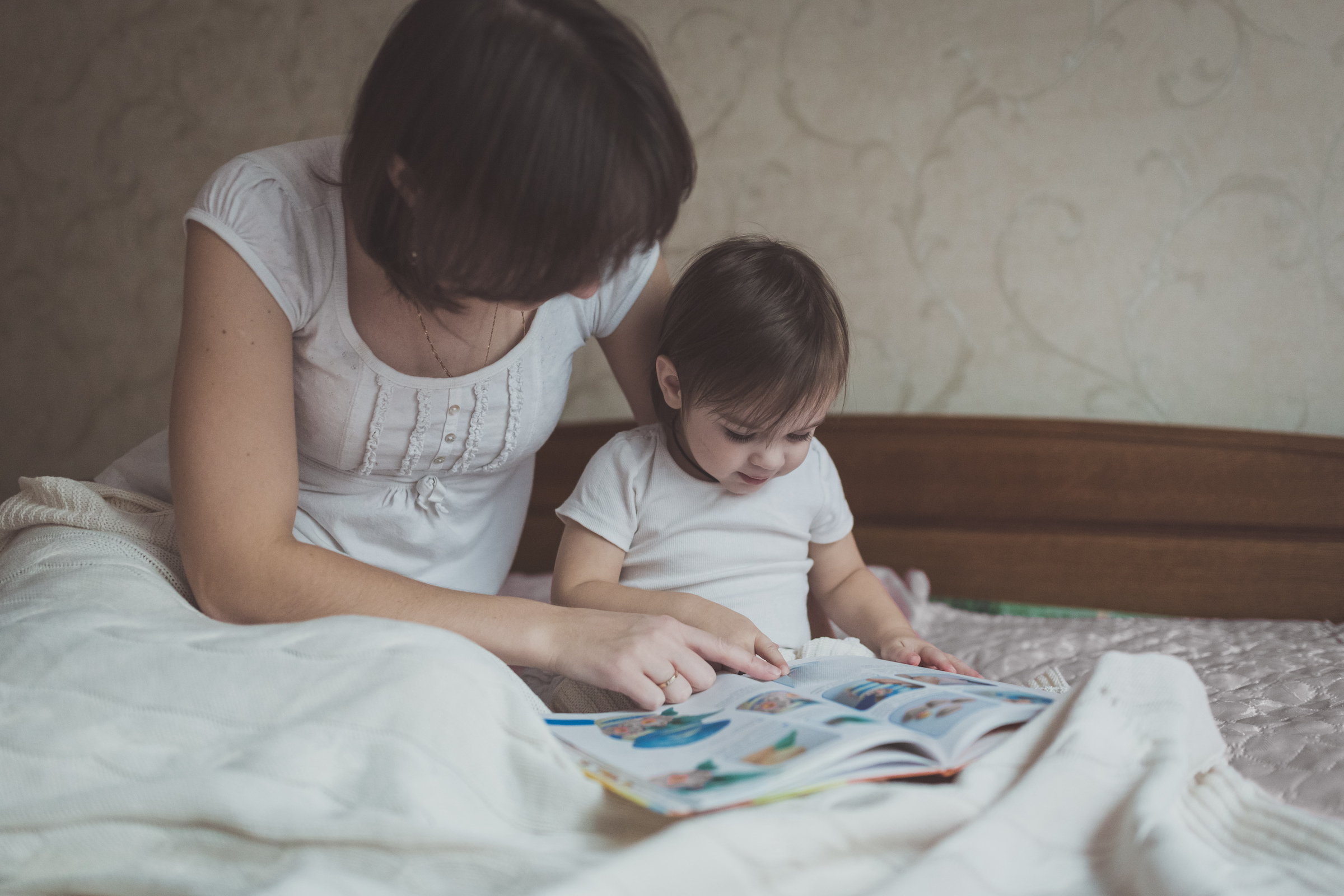 reading to toddler in bed